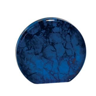 Blue round plate with a dark blue marbled pattern on a white background, photographed from above.