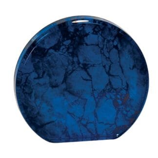 Deep blue round ceramic plate with a marbled, glossy finish viewed from above.