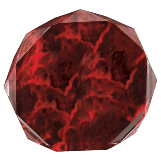 Close-up of a faceted red gemstone with marbled red and black patterns, showing its angular facets and glossy surface.