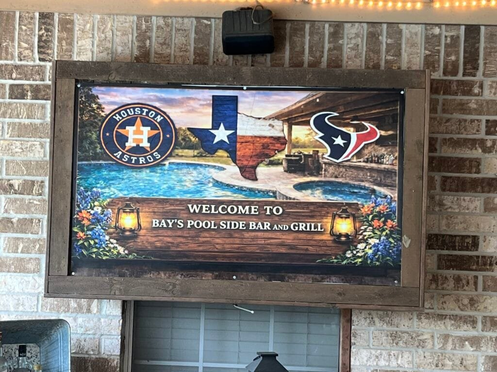 Custom outdoor patio sign featuring full-color graphics and printed banner installed in a rustic wood frame by Trophies Etc. in Baytown, TX.