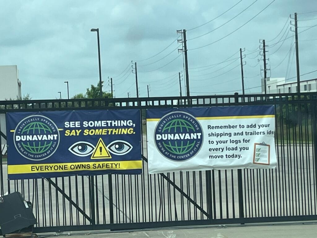 Custom outdoor safety banners printed and installed for Logistics warehouse entrance by Trophies Etc. in Baytown, TX.