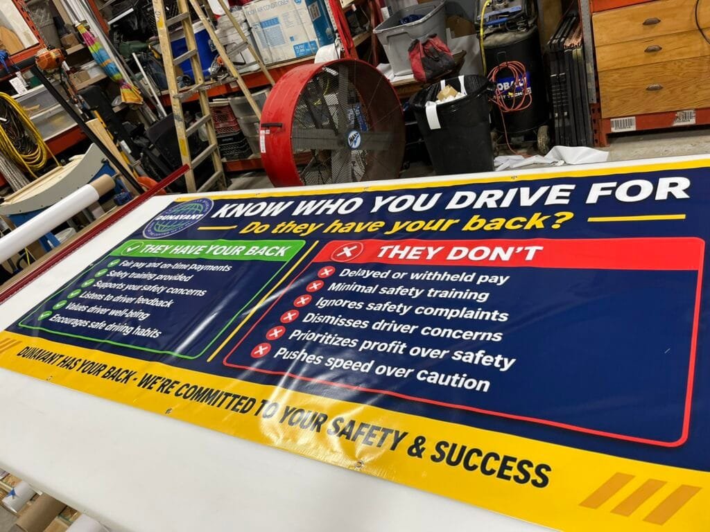 Custom warehouse safety banner printed by Trophies Etc. in Baytown, TX using HP Latex wide-format printing.